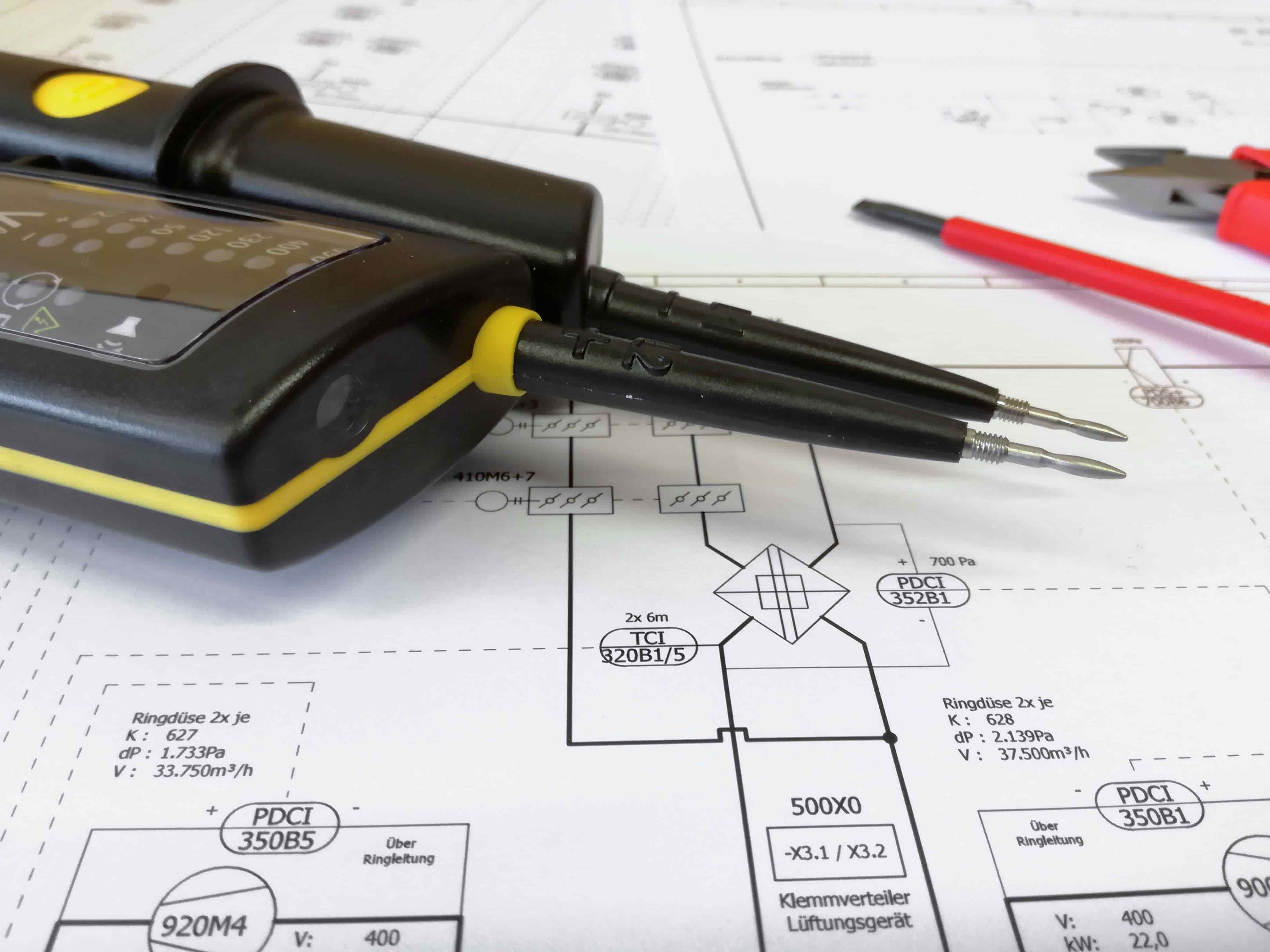 picture of electrical drawing with a multimeter on top